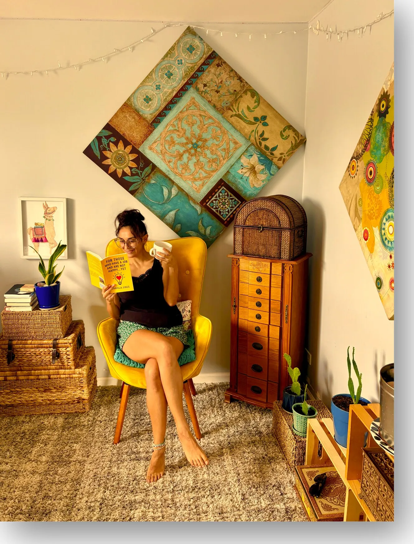 Daniela reading in a sunny corner, curled up in a yellow armchair