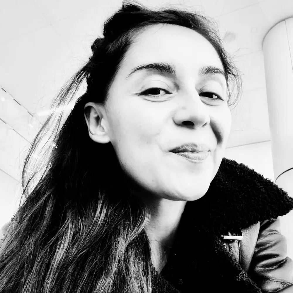 Black-and-white close-up of Daniela smiling